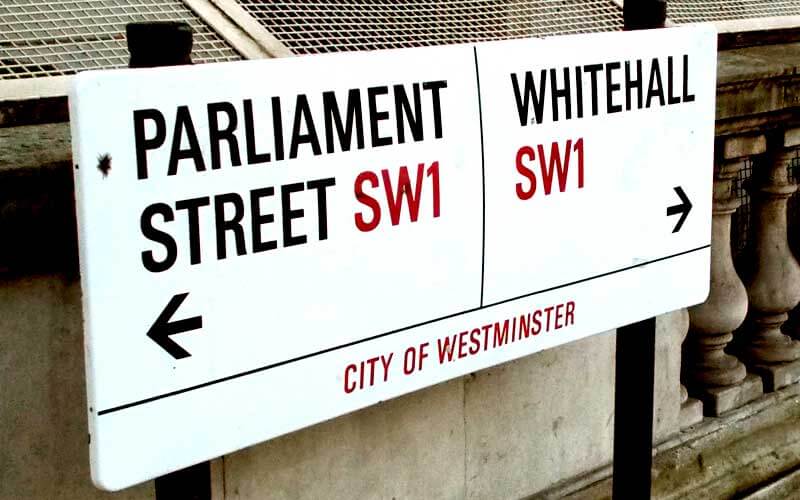 A sign pointing to Parliament Street and Whitehall