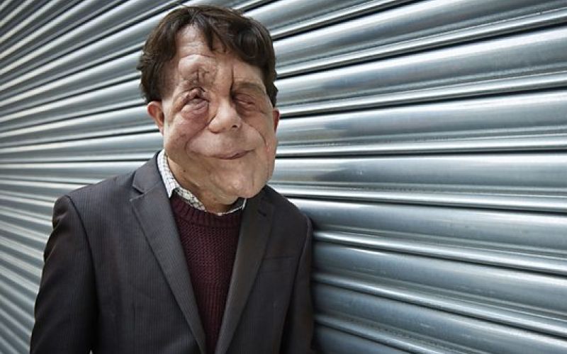 Adam Pearson, leaning against a fence