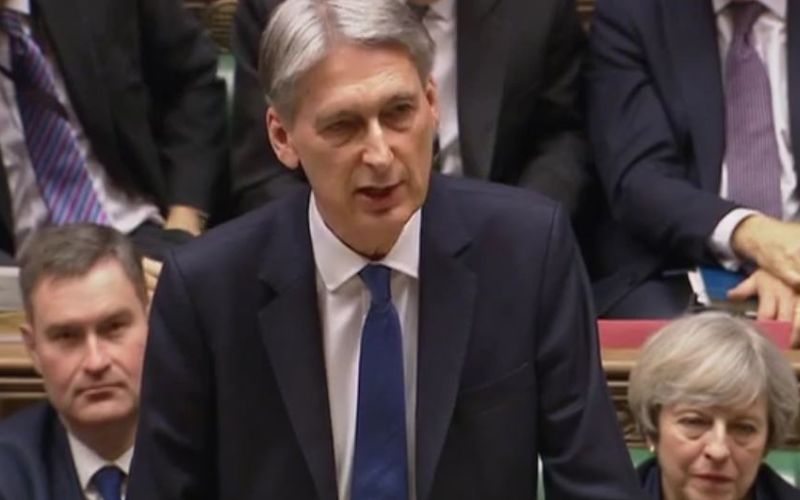 Philip Hammond delivering the budget, watched by the prime minister behind him