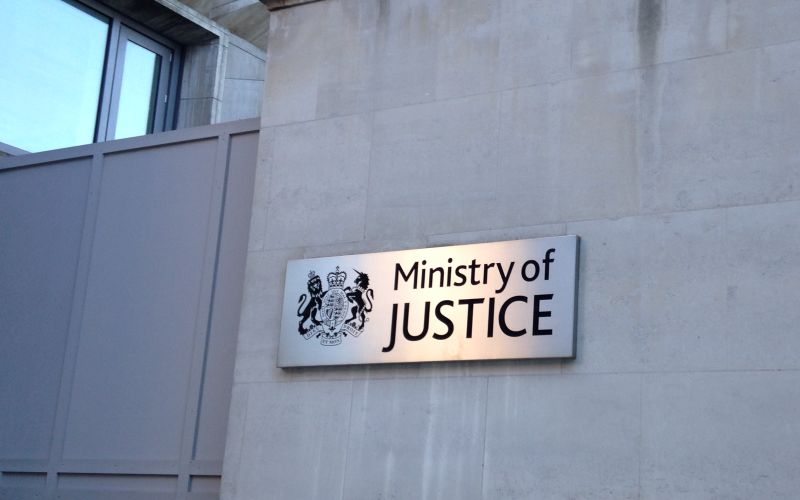 A Ministry of Justice sign on a grey wall