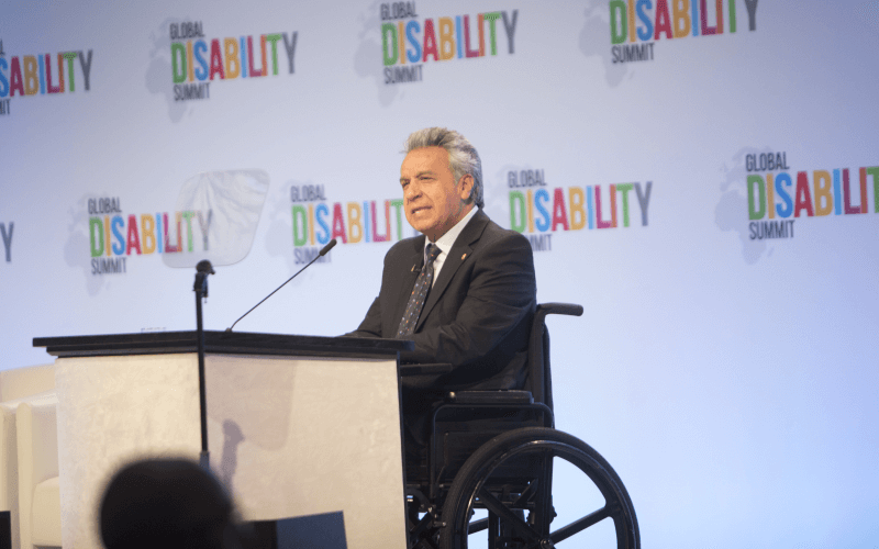 President Moreno speaking at a podium at the Global Disability Summit