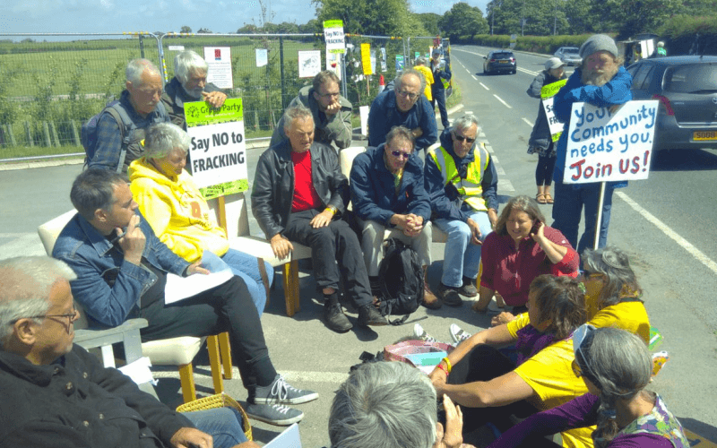 Jonathan Bartley sitting with protesters at Preston New Road