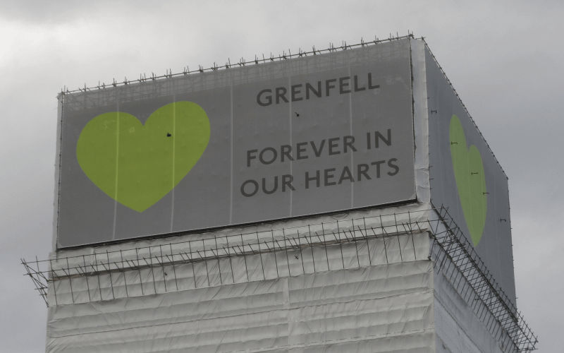 Disabled people had rights breached before and after Grenfell fire, says watchdog Banner saying Grenfell Forever in our Hearts